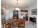 Dining room with a traditional wooden dining set under an elegant chandelier, with glimpses into the kitchen and living spaces at 8568 Windsor Ridge Dr, Charlotte, NC 28277