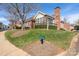 Charming brick building featuring mature tree, green lawn, a quaint fence and well-manicured bushes at 8568 Windsor Ridge Dr, Charlotte, NC 28277