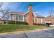Attractive brick home exterior with a prominent chimney, well-kept lawn, and privacy hedges at 8568 Windsor Ridge Dr, Charlotte, NC 28277