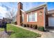 Exterior view of a brick home, showcasing well-manicured landscaping, and a neatly kept lawn at 8568 Windsor Ridge Dr, Charlotte, NC 28277