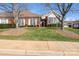 Well-maintained front yard of a brick home, featuring lush green grass and mature trees at 8568 Windsor Ridge Dr, Charlotte, NC 28277