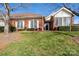 Beautiful front yard view of a brick home with manicured landscaping and mature trees at 8568 Windsor Ridge Dr, Charlotte, NC 28277