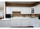 Bright kitchen with white cabinetry, countertops, and appliances and dark wood-look floors. Brown accent paint above cabinets at 8568 Windsor Ridge Dr, Charlotte, NC 28277