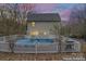 Backyard features a pool with a safety fence and lush greenery, perfect for outdoor relaxation at 946 Laurelwood Dr, Clover, SC 29710