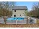 Backyard with inground covered pool, surrounded by a fenced wooden deck, and mature trees at 946 Laurelwood Dr, Clover, SC 29710