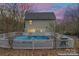 Backyard with inground covered pool, surrounded by a fenced wooden deck, and string lights at 946 Laurelwood Dr, Clover, SC 29710