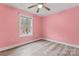 Bright bedroom with a ceiling fan, wood-look floors, and a window providing natural light at 946 Laurelwood Dr, Clover, SC 29710