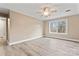 Bright bedroom features wood-look flooring, a ceiling fan, and a large window at 946 Laurelwood Dr, Clover, SC 29710