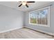 Bedroom with a ceiling fan, light grey walls, hardwood floors, and a large window at 946 Laurelwood Dr, Clover, SC 29710