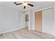 Bedroom featuring a ceiling fan, wood floors, closet, and access to another room at 946 Laurelwood Dr, Clover, SC 29710