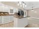 Kitchen showcasing an island and stainless steel appliances with open access to the living room at 946 Laurelwood Dr, Clover, SC 29710