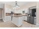 The well-lit kitchen features stainless steel appliances, a central island, and white cabinetry at 946 Laurelwood Dr, Clover, SC 29710