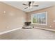 Living room features a cozy fireplace, ceiling fan, and a large window with natural light at 946 Laurelwood Dr, Clover, SC 29710