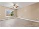 The room has a ceiling fan, neutral walls and a window overlooking the outdoors at 946 Laurelwood Dr, Clover, SC 29710