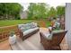 Well-furnished wooden deck with comfortable seating and a view of the expansive backyard at 1006 Baldwin Ln, Waxhaw, NC 28173