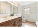 Bathroom featuring double sinks with wood cabinets and neutral walls at 1006 Baldwin Ln, Waxhaw, NC 28173