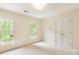 Neutral bedroom featuring carpet, double door closet, and windows providing plenty of natural light at 1006 Baldwin Ln, Waxhaw, NC 28173