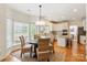 Bright dining area featuring a round table with wicker chairs, adjacent to the modern kitchen at 1006 Baldwin Ln, Waxhaw, NC 28173