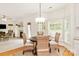 Dining area with a round table, wicker chairs, and natural light from surrounding windows at 1006 Baldwin Ln, Waxhaw, NC 28173