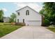 Rear exterior view of the home, featuring a deck, two-car garage, and lush backyard at 1006 Baldwin Ln, Waxhaw, NC 28173