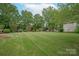 Expansive front yard with mature trees and landscaping providing curb appeal to the property at 1006 Baldwin Ln, Waxhaw, NC 28173