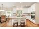 Bright, open kitchen with granite countertops, stainless steel appliances, and an island with seating at 1006 Baldwin Ln, Waxhaw, NC 28173