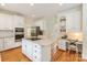 Bright, open kitchen with granite countertops, stainless steel appliances, and a convenient desk area at 1006 Baldwin Ln, Waxhaw, NC 28173
