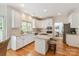 Bright, open kitchen with granite countertops, stainless steel appliances, and an island with seating at 1006 Baldwin Ln, Waxhaw, NC 28173