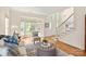 Bright living room with large windows, a staircase, and stylish furniture arranged on a patterned rug at 1006 Baldwin Ln, Waxhaw, NC 28173
