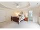Large main bedroom with tray ceilings, ceiling fan, and neutral walls at 1006 Baldwin Ln, Waxhaw, NC 28173