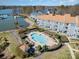 Aerial view of a pool and lake with condos in the background at 1008 Southwest Dr # 8, Davidson, NC 28036