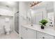 Bright bathroom features shower with glass doors, white vanity, and storage at 1008 Southwest Dr # 8, Davidson, NC 28036