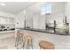 Bright kitchen features bar seating, stainless steel appliances, white cabinets and natural light at 1008 Southwest Dr # 8, Davidson, NC 28036