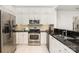 Modern kitchen features white cabinets, stainless steel appliances, and granite countertops at 1008 Southwest Dr # 8, Davidson, NC 28036