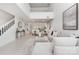 Open-concept living space with tall ceilings, stairs, and comfortable seating area at 1008 Southwest Dr # 8, Davidson, NC 28036