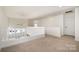 Loft area featuring railing, ceiling fan, and neutral colored carpet at 1008 Southwest Dr # 8, Davidson, NC 28036