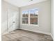 Sunlit room with wood-style floors and bright windows offer picturesque outdoor views at 108 Glencoe Ln # 105, Mooresville, NC 28117