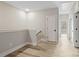 Bright hallway featuring neutral walls, wood floors, and natural light streaming in through an adjacent room at 108 Glencoe Ln # 105, Mooresville, NC 28117