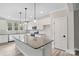 Modern kitchen showcasing white cabinetry, granite countertops, stainless steel appliances and an oversized kitchen island at 108 Glencoe Ln # 105, Mooresville, NC 28117