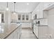 Modern kitchen featuring white cabinets, granite countertops, stainless steel appliances, and an oversized kitchen island at 108 Glencoe Ln # 105, Mooresville, NC 28117
