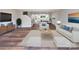 Bright, open-concept living room with hardwood floors, modern furniture, and a view into the dining area and kitchen at 108 Glencoe Ln # 105, Mooresville, NC 28117