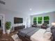 Inviting main bedroom with a large window, neutral walls, hardwood floors and plenty of natural light at 108 Glencoe Ln # 105, Mooresville, NC 28117