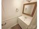 A cozy bathroom featuring a classic vanity and a framed mirror at 10905 Park Rd, Charlotte, NC 28226