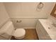 Bright bathroom with a white toilet, neutral walls and floors, and a white vanity at 10905 Park Rd, Charlotte, NC 28226