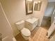 A cozy bathroom featuring a classic vanity, toilet, and shower at 10905 Park Rd, Charlotte, NC 28226