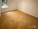 Bedroom with a window offering natural light and carpeted floors at 10905 Park Rd, Charlotte, NC 28226