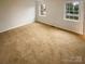 Clean, carpeted bedroom with neutral walls and natural lighting through two windows at 10905 Park Rd, Charlotte, NC 28226