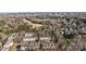 Community aerial view showcases the proximity to a golf course and mature trees at 11013 Dundarrach Ln, Charlotte, NC 28277