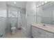 Well-lit bathroom with a sink, vanity, toilet, and shower-tub combo at 11013 Dundarrach Ln, Charlotte, NC 28277