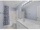 Bathroom features a shower with blue curtain, toilet, and a large mirror at 11013 Dundarrach Ln, Charlotte, NC 28277
